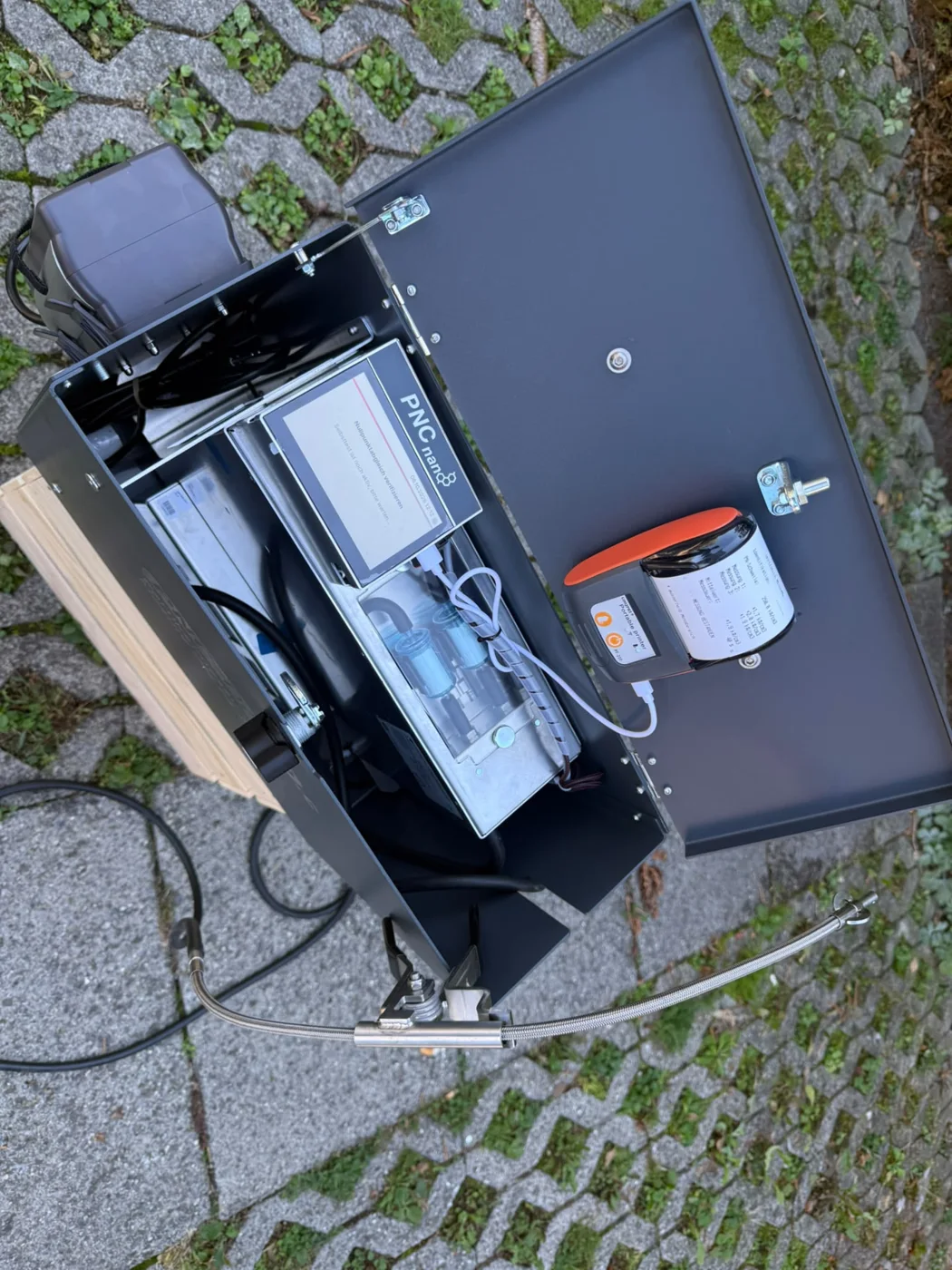 Geöffnetes PNC-nano Partikelmessgerät mit Messdisplay, Abgassonde und Protokolldrucker